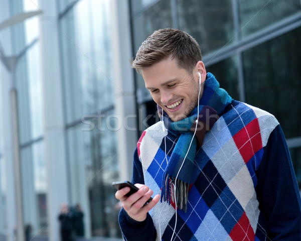 Young man listening  music on his mobile Stock photo © stockyimages