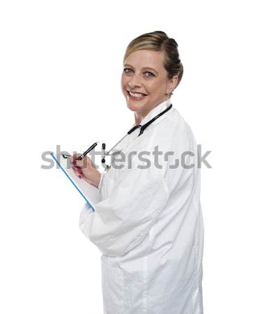 Deneyimli doktor yazı reçete gülen kadın Stok fotoğraf © stockyimages