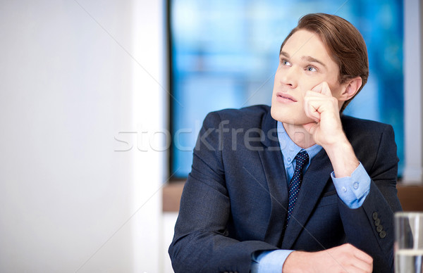 Young classy businessman thinking Stock photo © stockyimages