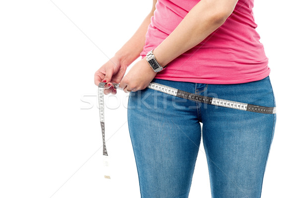 Closeup picture of woman with measure tape Stock photo © stockyimages