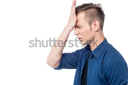 Casual man with hand on head Stock photo © stockyimages