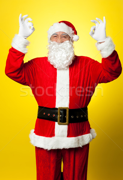 Aged Santa gesturing perfect sign with both hands Stock photo © stockyimages