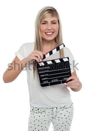 Attractive senior woman using clapperboard Stock photo © stockyimages