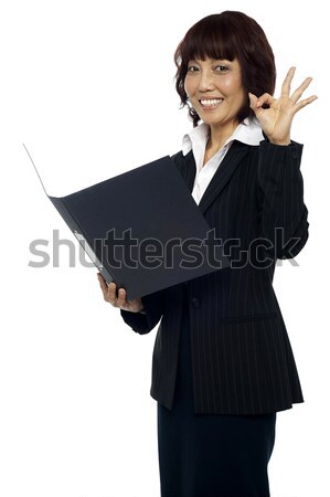 Lady consultant satisfied with the report Stock photo © stockyimages