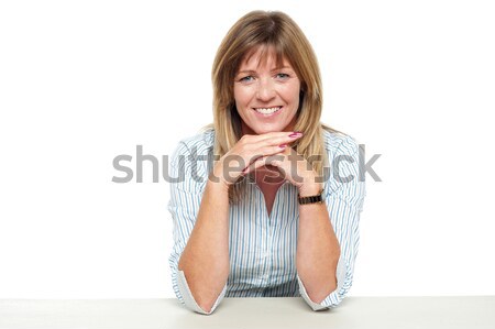 Smiling business lady sitting idle in office Stock photo © stockyimages