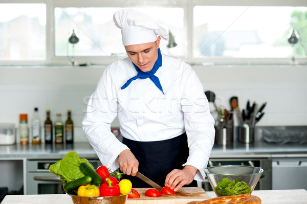 Chef carefully chopping vegetables Stock photo © stockyimages