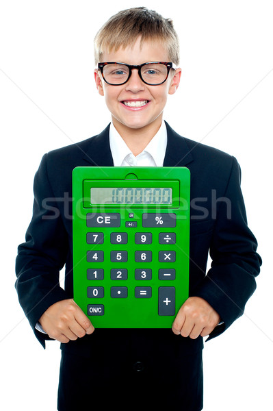 Bright young kid holding large green calculator Stock photo © stockyimages