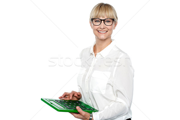 Secretary using large green calculator Stock photo © stockyimages