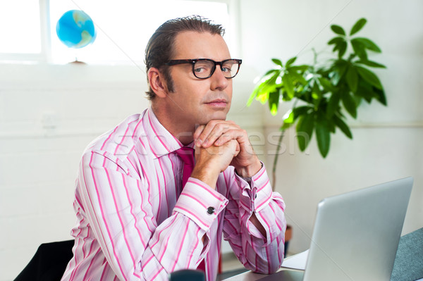 Idle corporate guy in office looking sideways Stock photo © stockyimages