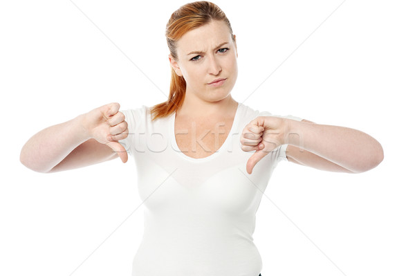 Stock photo: Young women showing thumbs down