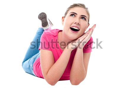 Amused teenage girl lying on flooor Stock photo © stockyimages