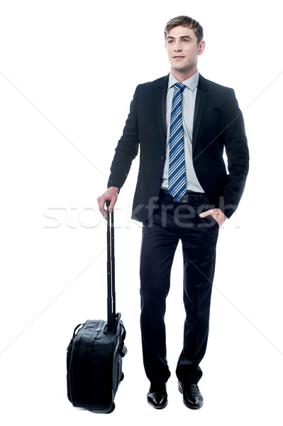 Young business man holding a trolley bag Stock photo © stockyimages