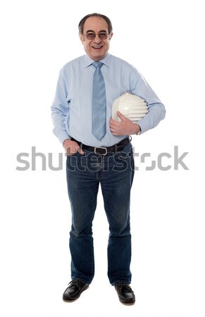 Senior architect holding hard-hat, full length Stock photo © stockyimages