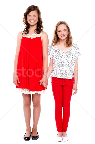 Stock photo: Beautiful sisters holding each others hand