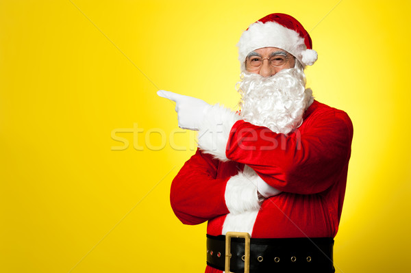 Kris Kringle gesturing towards the copy space area Stock photo © stockyimages