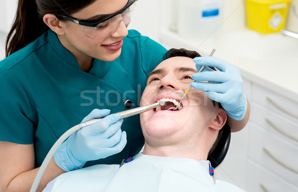 Male getting his teeth examined. Stock photo © stockyimages