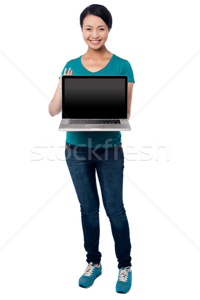 Salesgirl presenting brand new laptop for sale Stock photo © stockyimages