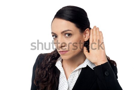 Business woman with hand to ear Stock photo © stockyimages