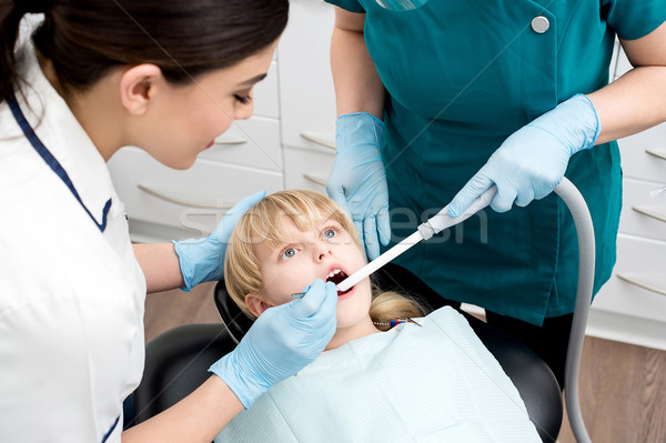 Dental assistant treat a little girl Stock photo © stockyimages
