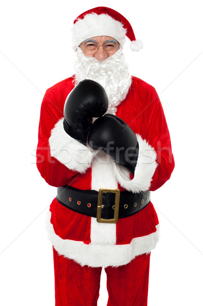 Aged cheerful Santa wearing boxing gloves Stock photo © stockyimages