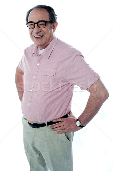 Casual man standing with hands on his waist Stock photo © stockyimages