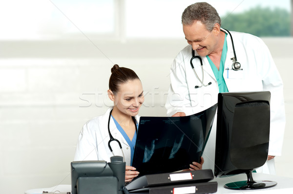 Team of surgeons discussing x-ray report Stock photo © stockyimages
