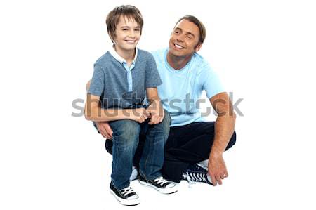 Affectionate father admiring his sweet son on his lap Stock photo © stockyimages