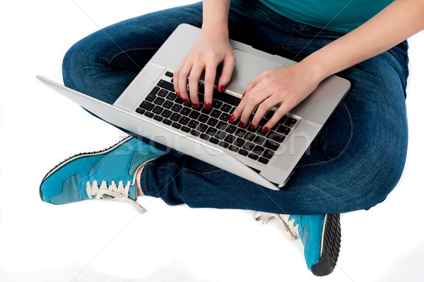 Cropped image of a girl working on laptop Stock photo © stockyimages