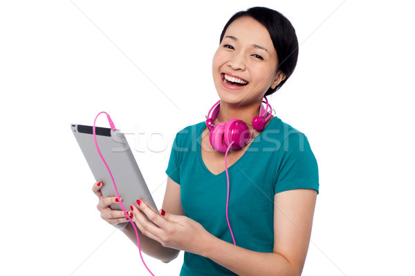Girl laughing out loud while watching funny video Stock photo © stockyimages