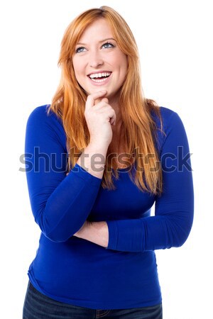 Young laughing woman imagining something Stock photo © stockyimages