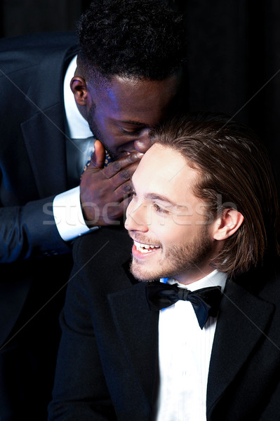 Man telling secret to his friend Stock photo © stockyimages