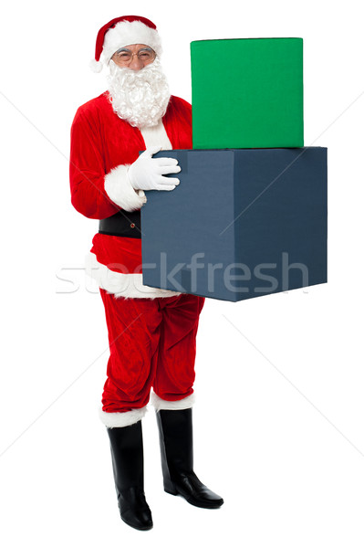 Photo of happy Santa Claus delivering gifts Stock photo © stockyimages