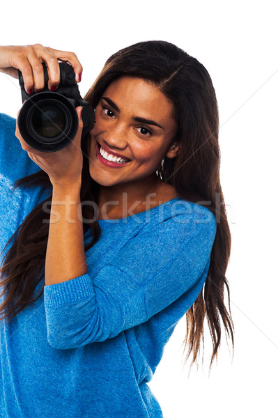Woman taking a snap, smile please Stock photo © stockyimages