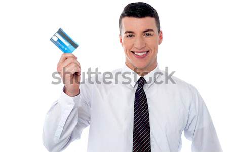 Businessman holding up credit card Stock photo © stockyimages