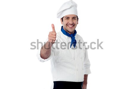 Young chef showing double thumbs up Stock photo © stockyimages