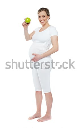 Stock photo: Pregnant woman showing fresh green apple