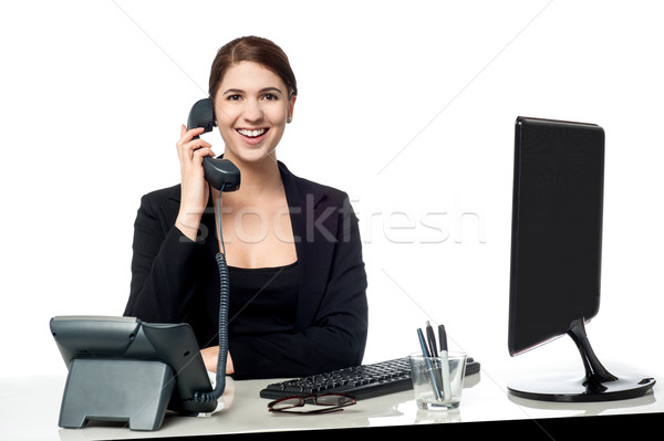 Female secretary answering phone call Stock photo © stockyimages
