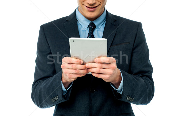 Businessman browsing on tablet pc Stock photo © stockyimages