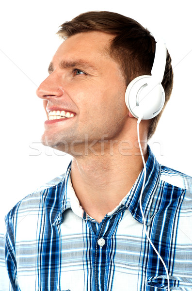 Young man tuned into music Stock photo © stockyimages