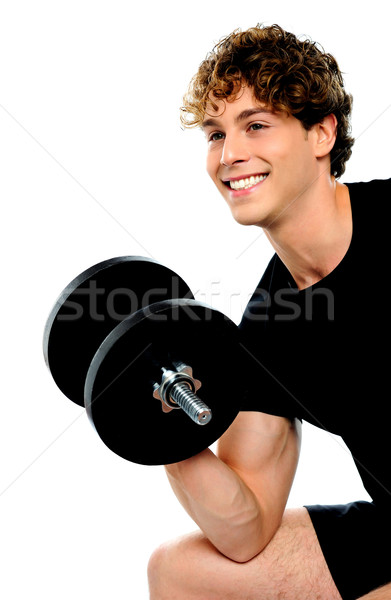 Muscular man in black sportswear with dumbbell Stock photo © stockyimages