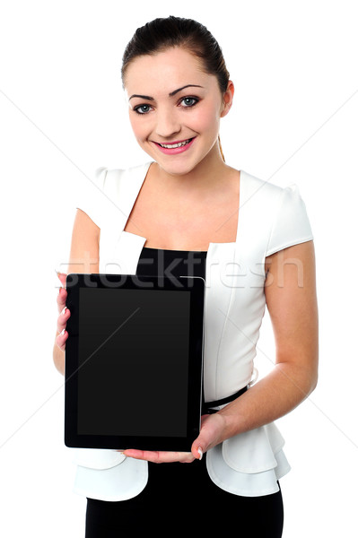 Pretty young girl showcasing a tablet device Stock photo © stockyimages