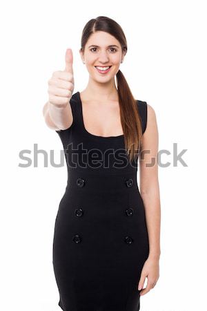 Attractive female gesturing thumbs up Stock photo © stockyimages