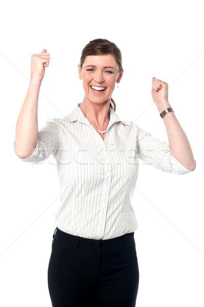 Excited corporate lady with clenched fists Stock photo © stockyimages