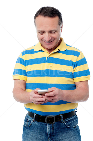 Stock photo: Casual aged man using mobile phone