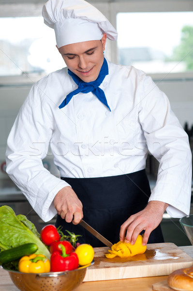 Chef cutting vegetables in kitchen Stock photo © stockyimages