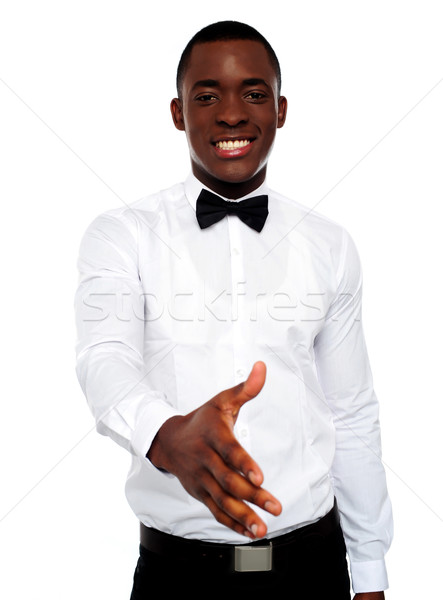 Attractive young man offering handshake Stock photo © stockyimages