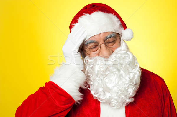 Portrait of Santa Claus suffering from headache Stock photo © stockyimages