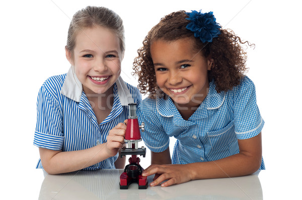 Kids in uniform playing with microscope Stock photo © stockyimages