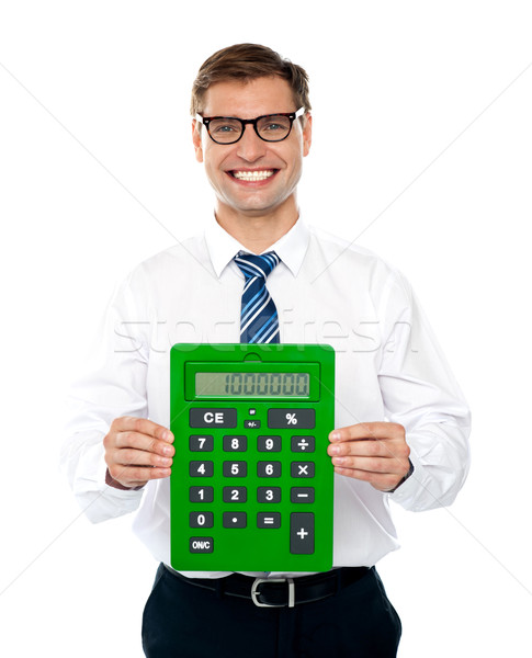 Male executive displaying green calculator Stock photo © stockyimages