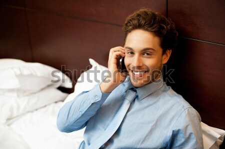 Businessman attending personal calls after work Stock photo © stockyimages